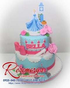 Two-tier Cinderella-themed cake adorned with delicate blue and pink frosting accents. Order your dream cake from Rosemary's Cakes: 0917-598-9215