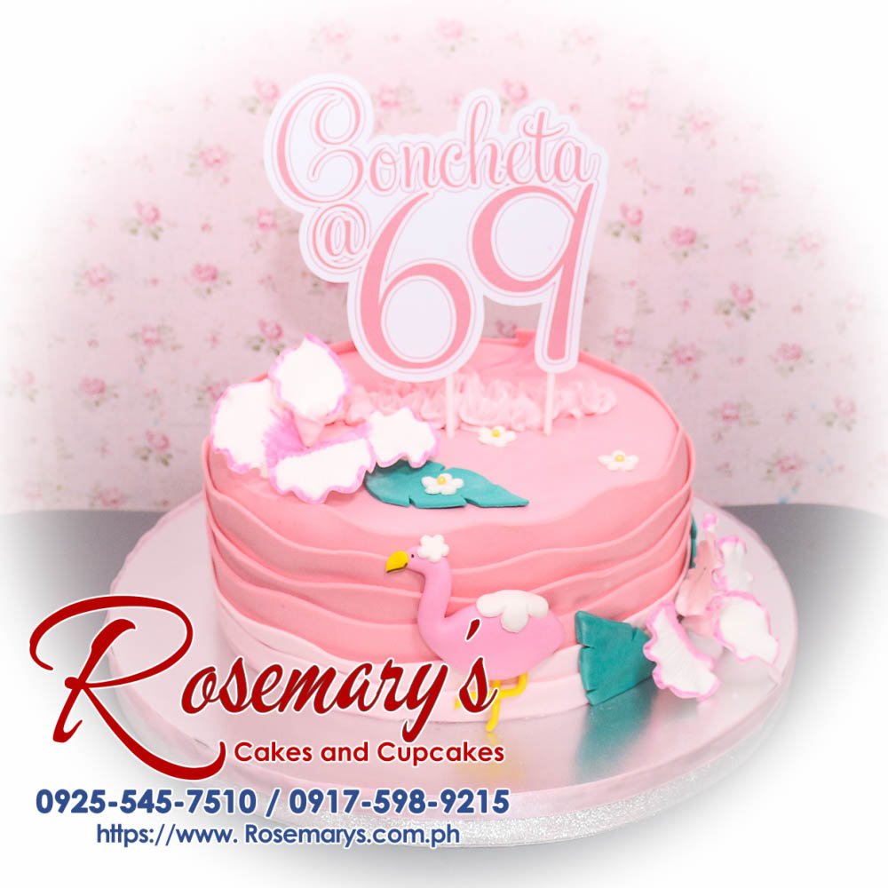 Flamingo Themed Cake for Concheta’s 69th Birthday Flamingo-themed pink 1-layer cake, adorned with vibrant decorations. For delicious cakes, contact Rosemary's Cakes: 0925-545-7510.