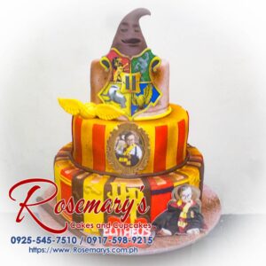 Three-layer chocolate cake adorned with edible Hogwarts crest and golden snitch. Perfect for Harry Potter fans! Order from Rosemary's Cakes: 0925-545-7510
