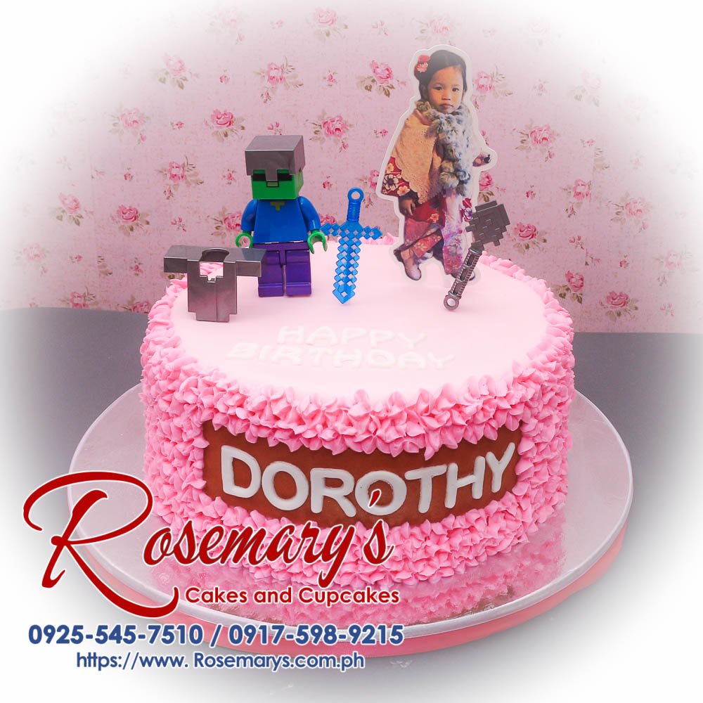 Minecraft Themed Icing Cake for Dorothy Decorative pink Minecraft-themed icing cake with vibrant block designs, perfect for any celebration. From Rosemary's Cakes, call 0925-545-7510.