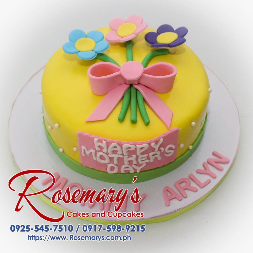 Delectable yellow cake adorned with pink frosting roses and edible leaves. Perfect for Mother's Day celebrations! Rosemary's Cakes | 0925-545-7510
