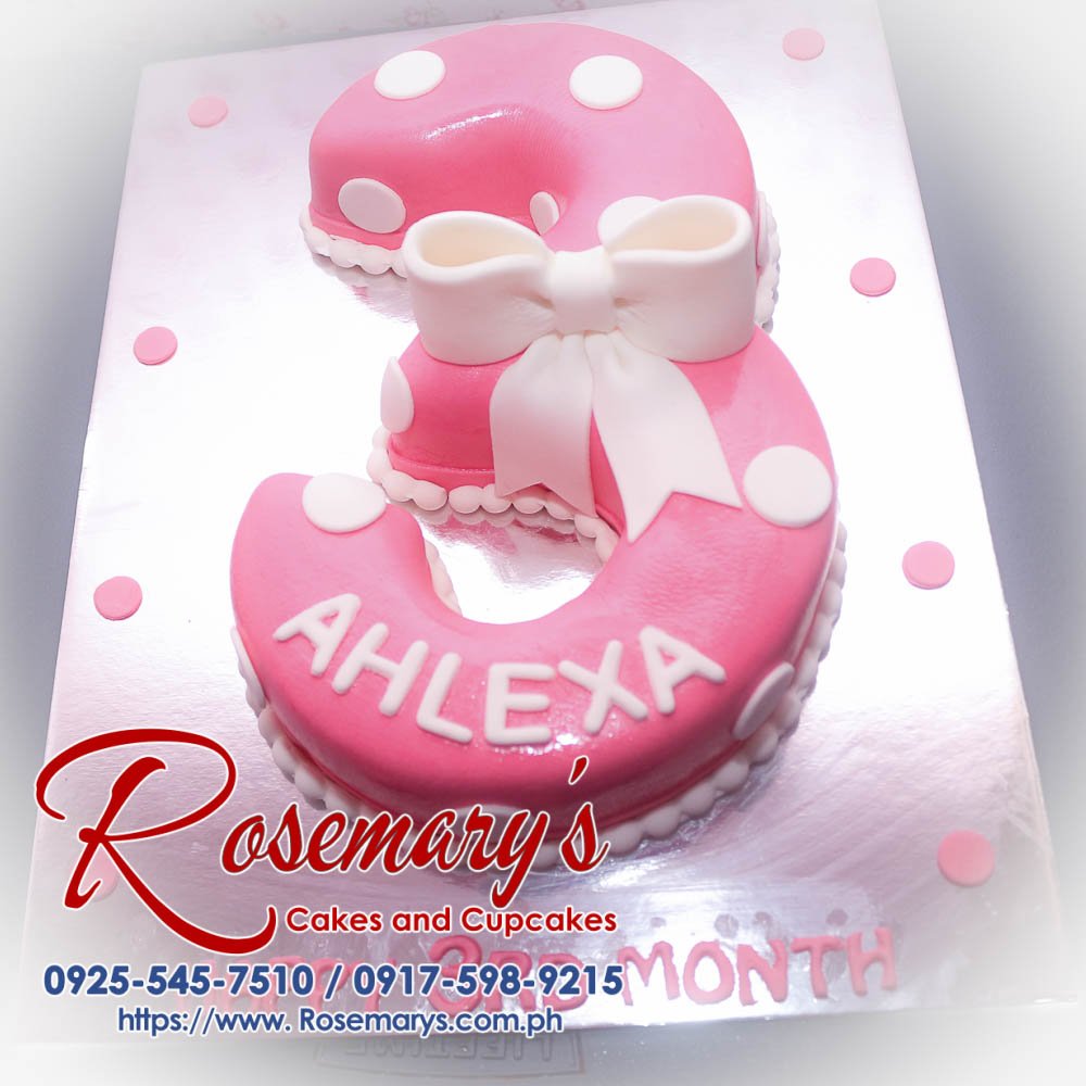 Number cake for Ahlexa Delicious pink number cake adorned with a ribbon, perfect for celebrations. Order from Rosemary's Cakes at 0925-545-7510.
