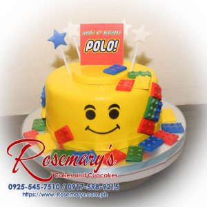 One layer Lego themed cake by Rosemary's Cakes, vibrant yellow with playful Lego designs. Contact: 0925-545-7510.