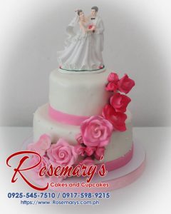 Delicious 2-tier pink and white wedding cake with elegant frosting details. Order yours from Rosemary's Cakes: 0917-598-9215.