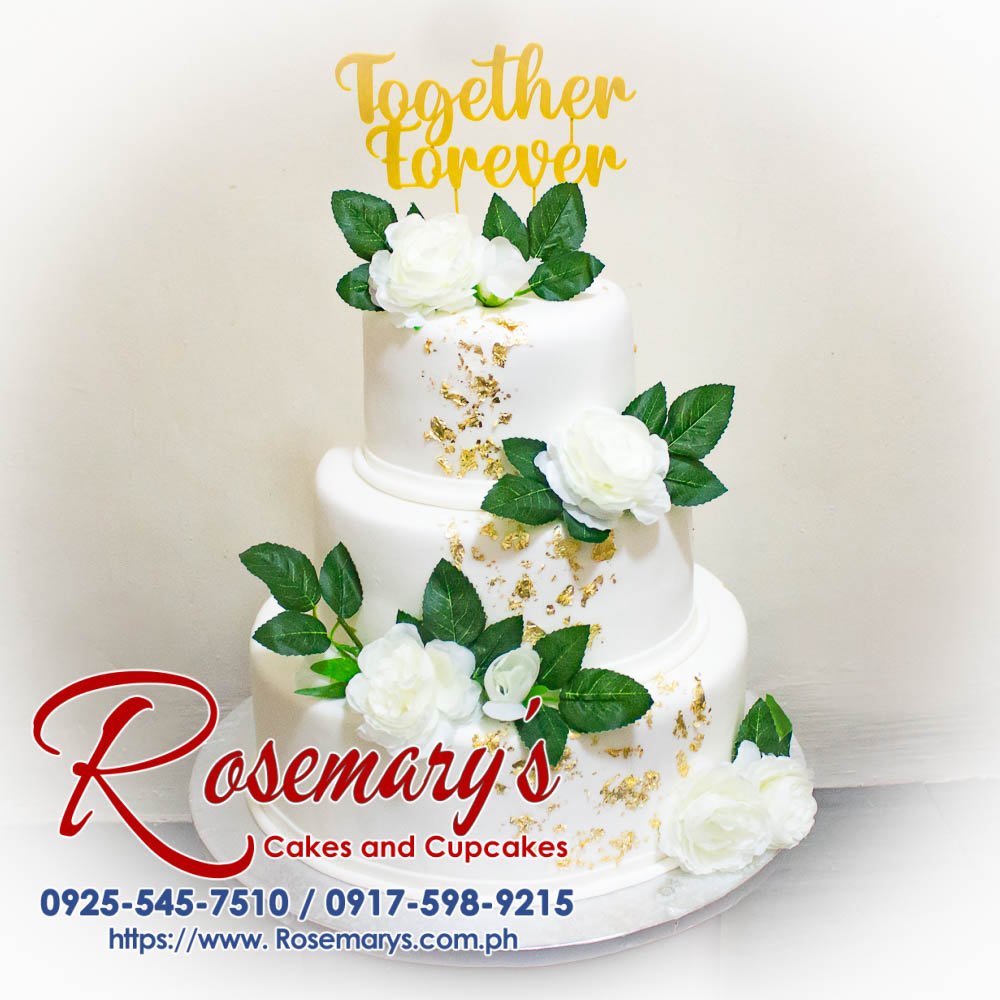 Elegant 2-layer white wedding cake adorned with delicate floral details, perfect for anniversary celebrations. Rosemary's Cakes, 0917-598-9215.