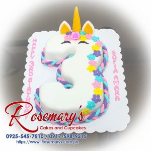 Colorful unicorn-themed number cake with vibrant frosting and whimsical decorations, perfect for birthdays. From Rosemary's Cakes, call 0925-545-7510.