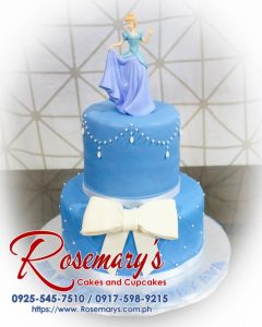 Delicious 2 layer Cinderella themed cake by Rosemary's Cakes, featuring intricate blue details and Disney princess designs. Contact 0917-598-9215.