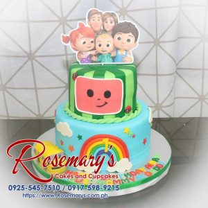 Delicious 2-layer Cocomelon themed cake in blue and green, adorned with a colorful rainbow. Order from Rosemary's Cakes: 0917-598-9215.