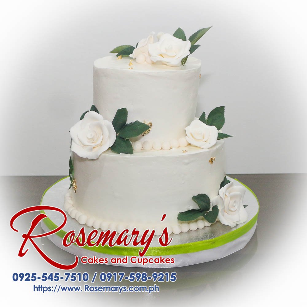 Elegant 2-layer wedding cake with smooth icing, floral accents, and intricate details. Order from Rosemary's Cakes at 0917-598-9215.