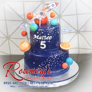 Delicious 2 layer space themed cake featuring planets and a rocket, crafted by Rosemary's Cakes. Contact: 0917-598-9215.