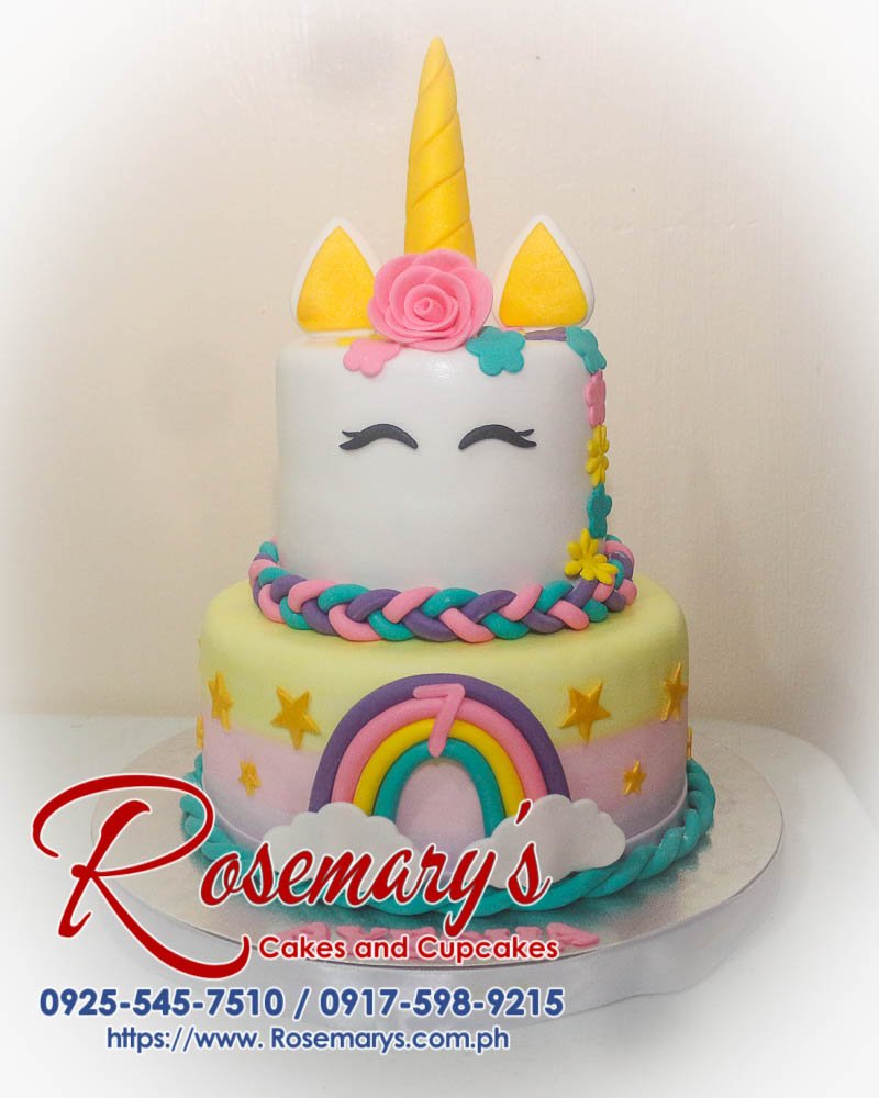 Delicious 2 layer unicorn cake with pastel colors and rainbow accents, perfect for themed celebrations. From Rosemary's Cakes, call 0917-598-9215.