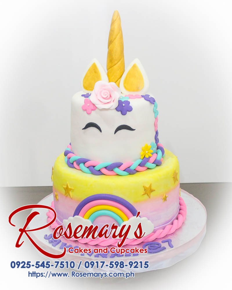 Delicious 2 layer unicorn cake with gold accents and pastel rainbow colors, perfect for any themed celebration. Rosemary's Cakes, 0917-598-9215.