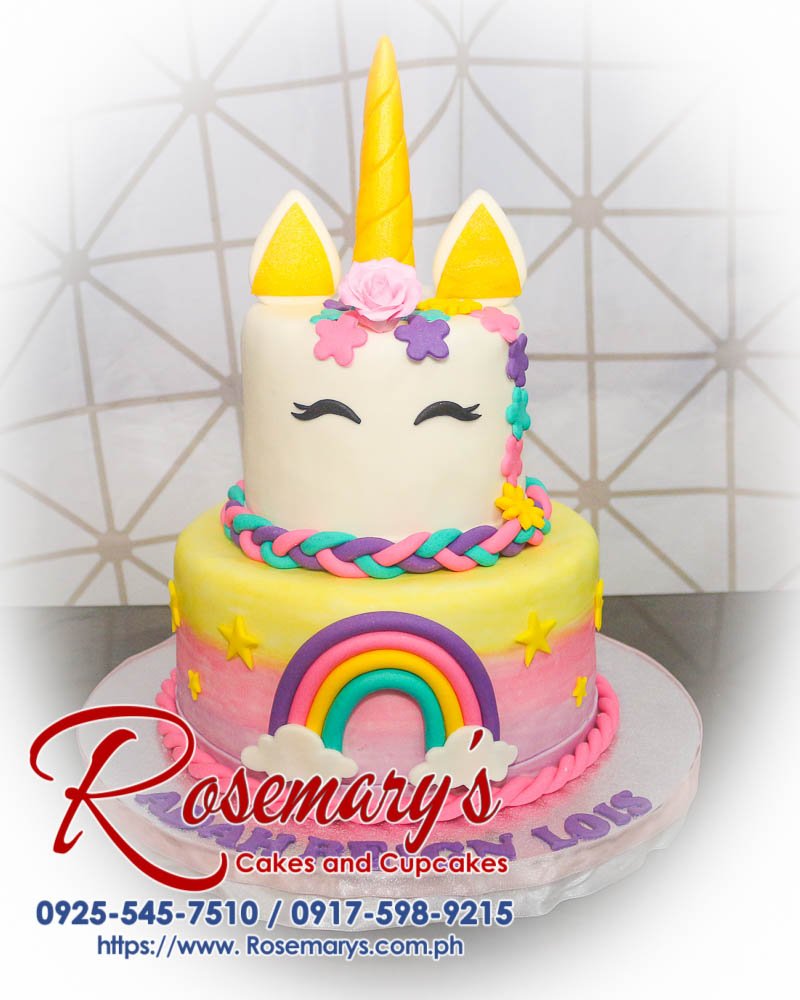Delicious 2 layer unicorn themed cake with pastel colors and rainbow details, crafted by Rosemary's Cakes. Contact: 0925-545-7510.