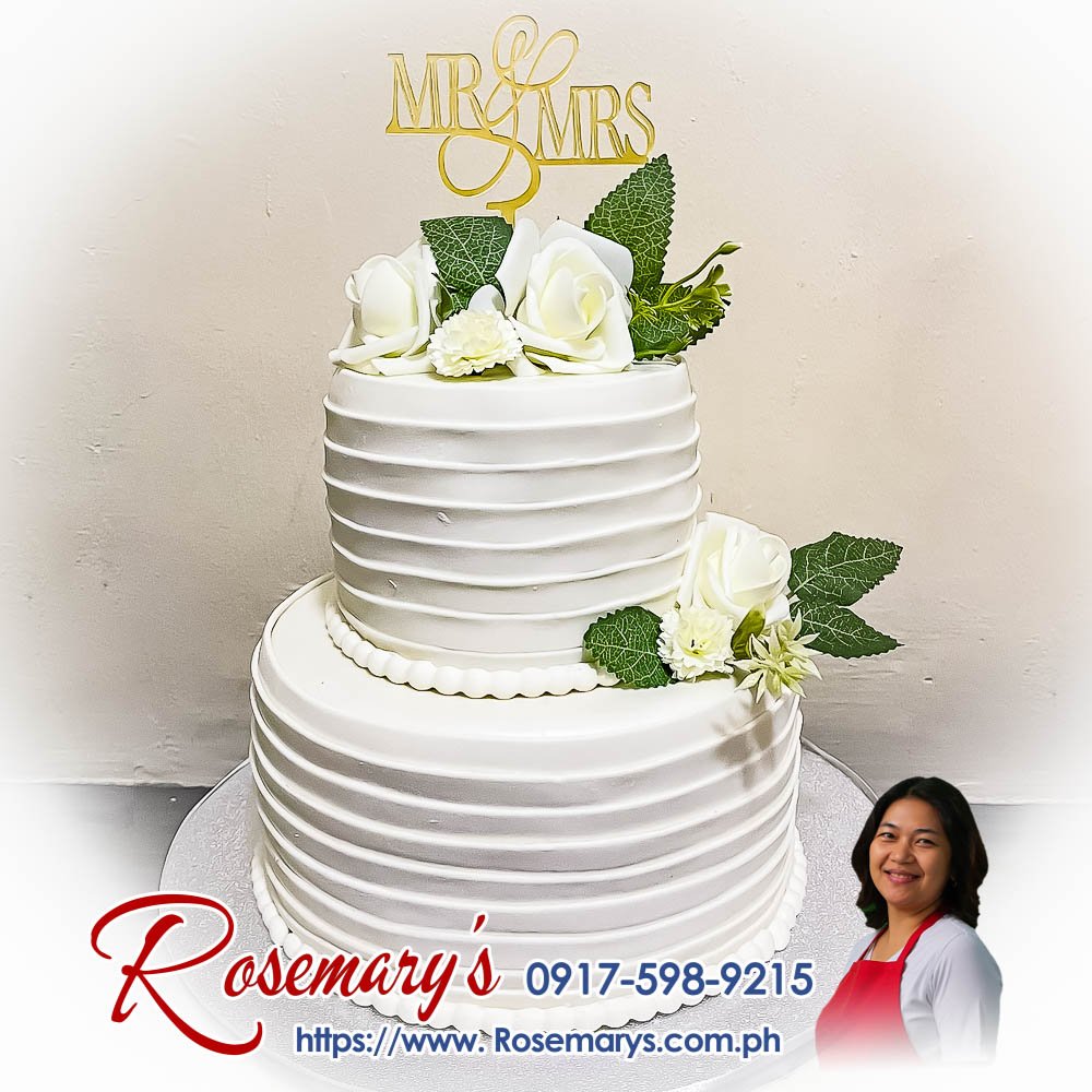2 layer mr and mrs white roses themed wedding cake Elegant 2-layer wedding cake adorned with white roses, perfect for Mr. and Mrs. celebrations. Contact Rosemary's Cakes at 0917-598-9215.