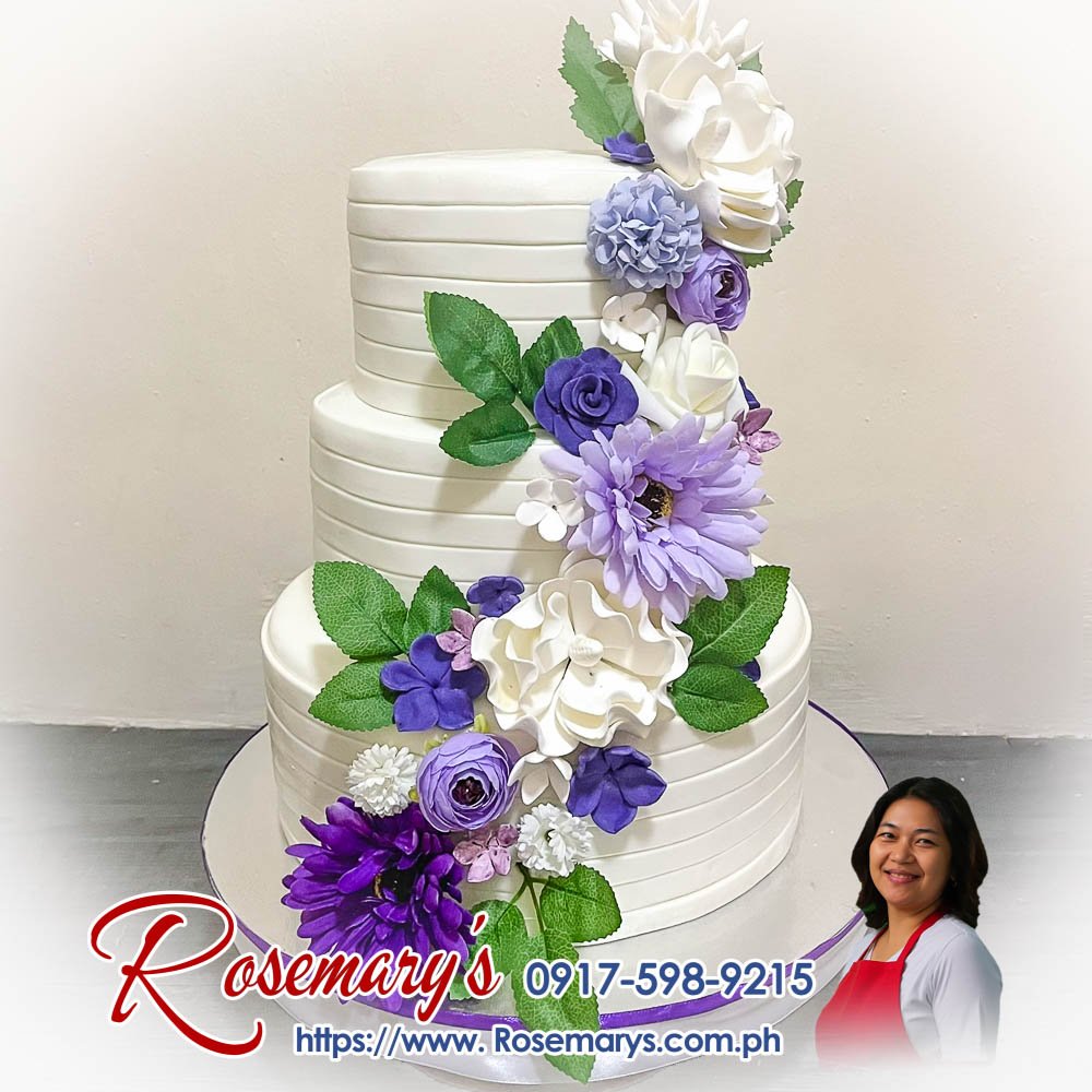 elegant white floral wedding cake Elegant white floral wedding cake with delicate blooms, featuring three layers of deliciousness. Order from Rosemary's Cakes, 0917-598-9215.